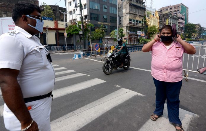 Kolkata: Police personnel intercept violaters during a complete lockdown for 21 days announced by Prime Minister Narendra Modi to prevent further spreading of the COVID 19 pandemic in India; in Kolkata on March 25, 2020. (Photo: Kuntal Chakrabarty/IANS)