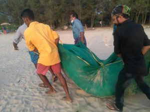 Fishermen carrying net 