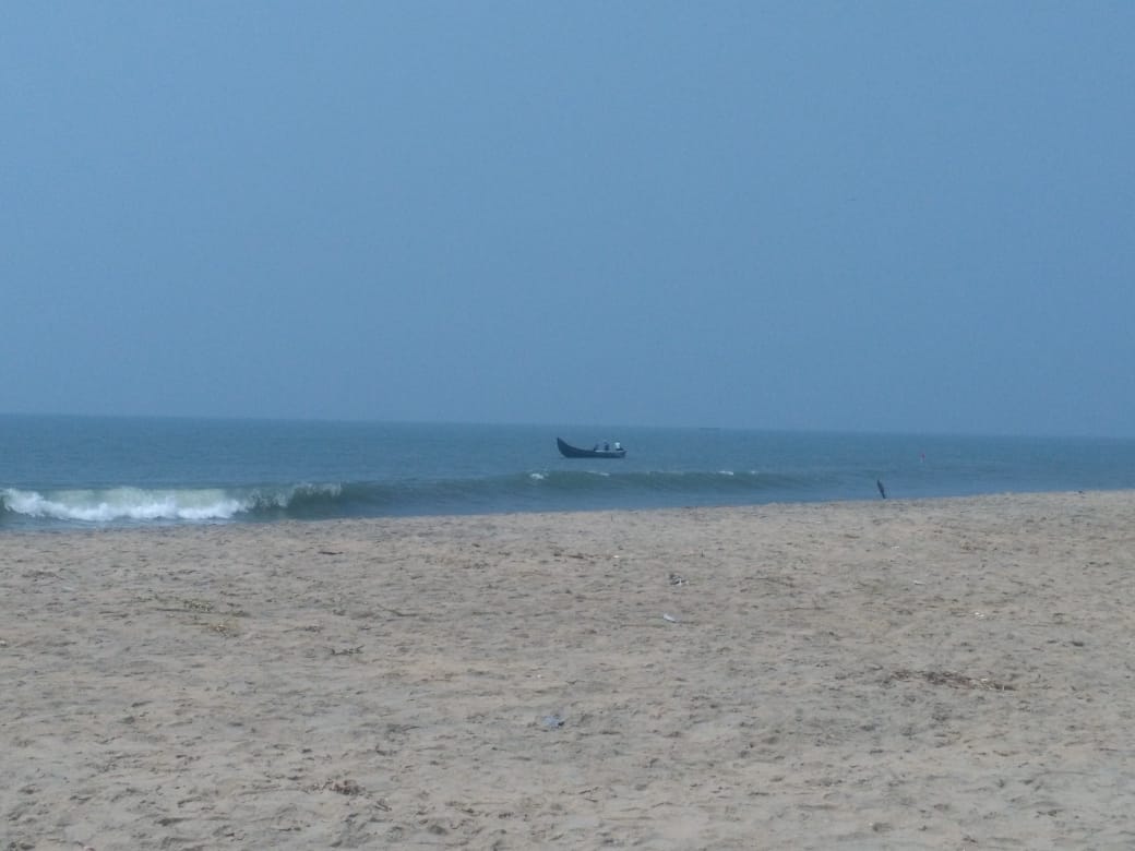 Malippuram beach, man fishing on small boat