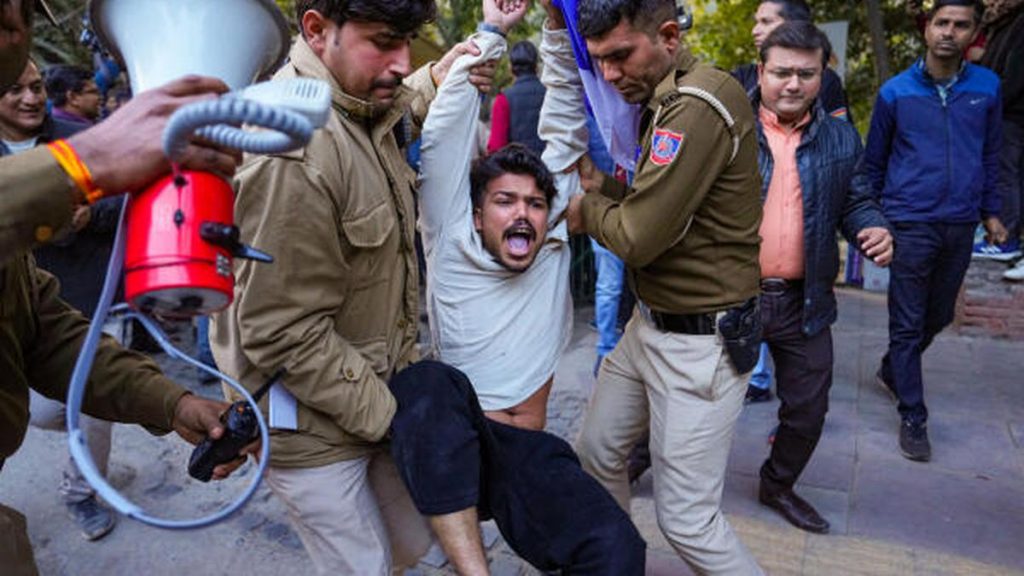 Police personnel detain students for planning to screen the BBC documentary film ‘India The Modi Question’ at Delhi University Arts Faculty in New Delhi on January 27, 2023. Photo Credit PTI